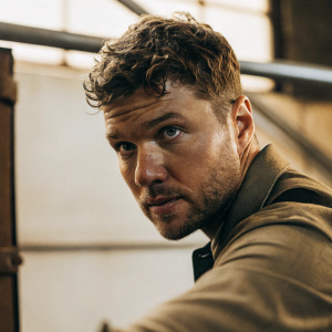 Close-up portrait of Ryan Phillippe. Short curly brown hair and stubble. Looking directly at the camera.