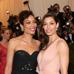 Rosario Dawson and Jessica Biel at a charity gala. Flashing cameras and other celebrities in attendance.