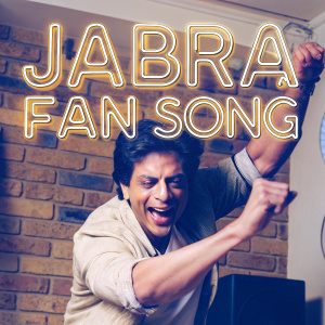 Promotional photo featuring Shah Rukh Khan. Joyful smile and energetic pose. 'Jabra Fan Song' text prominently displayed. Rustic brick wall background. Fun and promotional style.