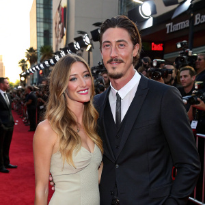 Erin Chiamulon and Eric Balfour, on the glamorous red carpet of the 'The Offer' premiere. Flashing cameras, paparazzi in the background.