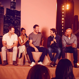 Chris Pratt, Zoe Saldana, Dave Bautista, Vin Diesel, and Bradley Cooper at a press conference for Guardians of the Galaxy. City skyline backdrop.