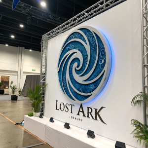 The Lost Ark emblem, a swirling blue masterpiece, dominating an empty white backdrop. Modern, sleek design showcasing the game's emblematic power.