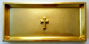 a gold rectangular plate without patterns on which an Orthodox cross is engraved in the middle