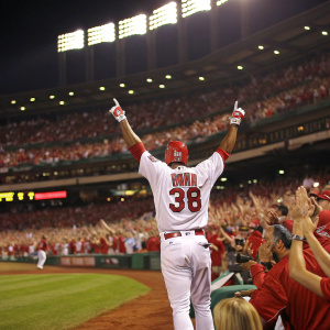 Kevin Brown, wearing jersey number 38, celebrates after hitting a home run. A sea of fans in the stadium cheer him on.