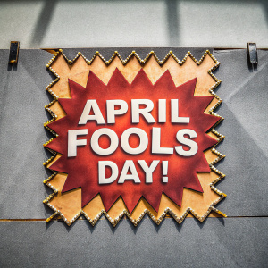 Comic strip panel with speech bubble. Jagged edges, red background. Text reads 'April Fools Day!' in bold white font.