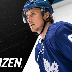 Tyler Bozak, hockey player, intense look on his face. White rink surface. Bold black background with 'izen' logo