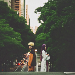 Naruto Uzumaki and Hinata Hyuga stand beside a busy city street. Cars honking, people rushing by.