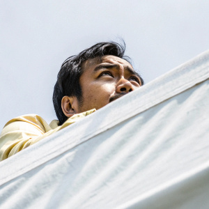 Close-up grayscale photograph of Jose Rizal. His prominent forehead and expressive eyes are highlighted against a plain, solid gray backdrop.