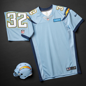 Eric Weddle's NFL jersey collection. A large light blue jersey with the number 32 and the Chargers emblem, alongside a miniature version. Both are displayed on a plain black background.