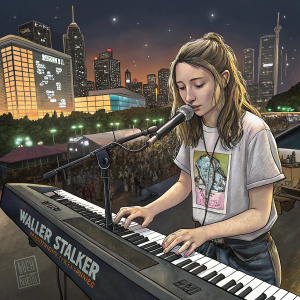 Katelyn Nacon, performing live at Walker Stalker Con Melbourne 2018. She's a young caucasian female in her late teens, playing a digital piano. She's dressed in a graphic tee. The background features a bustling cityscape at night.