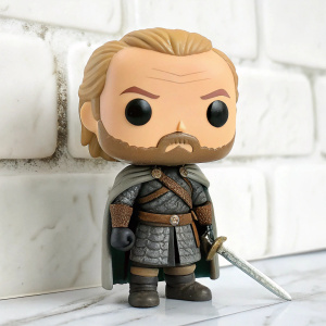 Funko Pop vinyl figurine of Jorah Mormont from Game of Thrones. Depicted with intense gaze, detailed facial hair, and sturdy armor. Clad in weathered cloak and belt. Standing still against minimalist white backdrop.