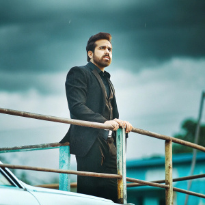 Emraan Hashmi, actor, in black suit. Promotional photo shoot for new movie. Dark, moody backdrop