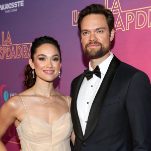 Shane West and Isabella Castillo attending the New York premiere of 'La Usurpadora The Musical'. They are both dressed in formal attire, with Isabella in a light-colored, elegant gown and Shane in a classic black tuxedo.