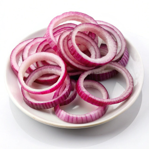 Sliced red onion rings on white plate on white background