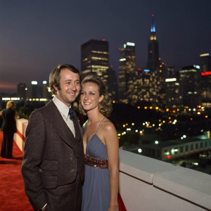 Michael Nesmith and Victoria Kennedy attend the Misery film premiere. L.A. night skyline backdrop