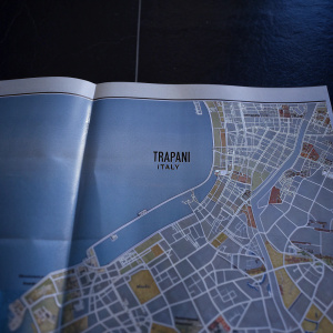 An old map of Trapani, Italy. Vibrant colors, detailed streets and landmarks. User-friendly design with clear labels. Nostalgic feel, reminiscent of historical charts.