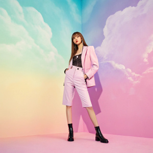 Lisa from BLACKPINK, Asian idol, standing in front of a vibrant gradient background of pastel shades. Stylish solo photoshoot