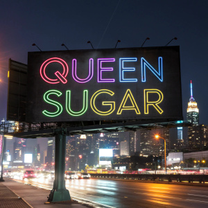 Promotional billboard for Queen Sugar TV series. Dark cityscape background with neon lights. Modern fonts, vibrant colors.