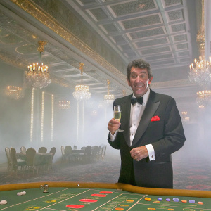 Dean Martin, elegant in black tuxedo, at glamorous casino event. White shirt, red pocket square, and dark bow tie. Holding a glass of champagne, cheerful demeanor.