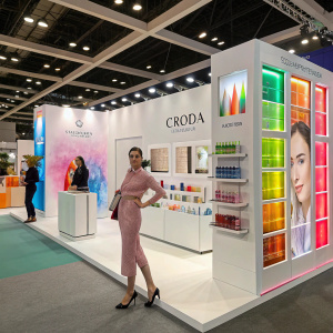 Croda Inc.'s booth at the Cosmetics Trade Show. Innovative designs, colorful displays, and models showcasing their products.