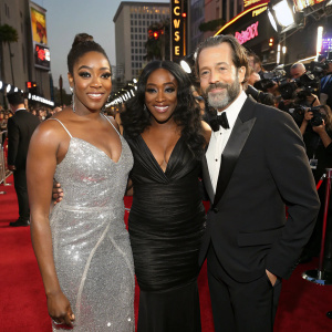 Tiffany Haddish, Remy Ma, and Jason Lee on the bustling Hollywood red carpet. Wearing glamorous attire.