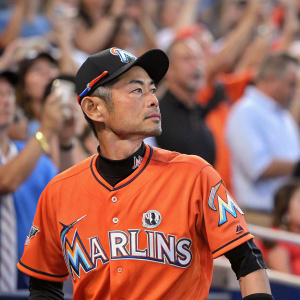 Ichiro Suzuki, Japanese baseball star, in Miami Marlins jersey. Orange and white uniform. Serious expression, focusing on the ball. Crowd cheering in the background.