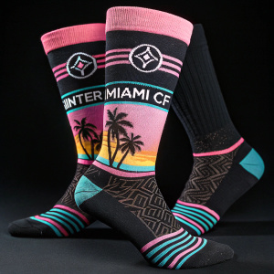 Close-up of Inter Miami CF socks. Black background. Athletic design