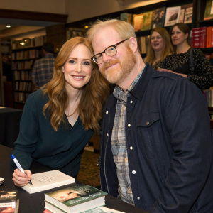Jaime Ray Newman and Jim Gaffigan from 'Royal Pains' at a book signing event. They wear casual attire and have a friendly demeanor.