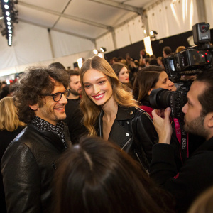 Aldo Montano, Alessandra Moschillo at John Richmond fashion show, lively backstage. Crowded and bustling, photographers flashing