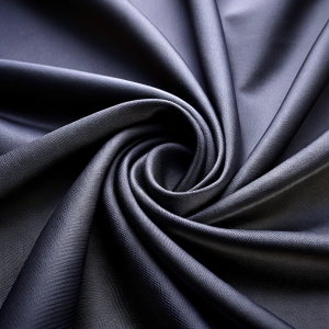 close up view black smooth fabric center fold background