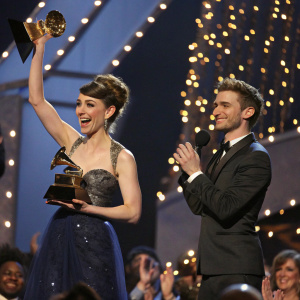 Amy Heidemann and Nick Louis Noonan on stage, celebrating win at Grammy Awards.
