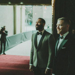 Omari Hardwick and Joseph Sikora at the Oscars. Wearing tuxedos, posing formally on the red carpet.