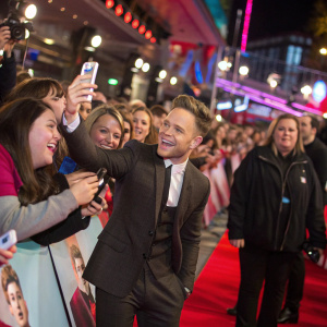 Screenshot from @ollyofficial's Twitter. A collage of Olly Murs with fans at a red carpet event. Crowd is vibrant and celebrating