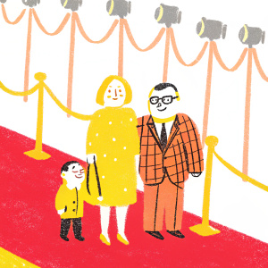 Premiere night for Kung Fu Panda 3. Clare De Chenu in black leather dress, Wayne Knight in suit, and their son in checkered jacket, standing on red carpet with flashing cameras and event logos in background.