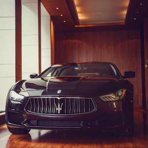 Luxury black Maserati Ghibli S Q4 Gransport on display at Miller Motorcars. Elegant showroom with sleek, neutral walls.