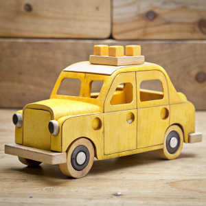 simple taxi figurine cut out of plywood with a jigsaw, artistic photo