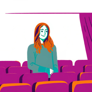 Olivia Wilde, with wavy brown hair and a soft smile, in a casual gray sweater, standing in a green room at a film festival.