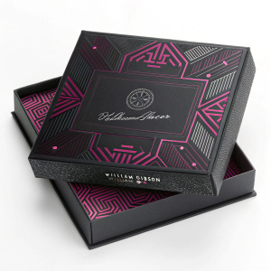 Limited edition collector's box for 'Neuromancer' by William Gibson. The design features a futuristic, colorful pattern with shades of black and magenta. The box includes intricate details and the author's signature.