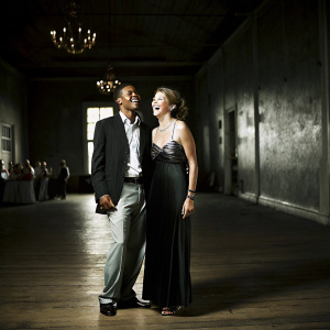 Yared Dibaba and Fernanda de Sousa Dibaba laughing together at a charity event.