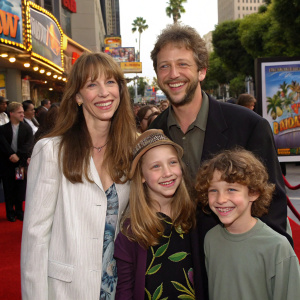 Laraine Newman and her family, including her husband and children, attending the premiere of 'The Wild Thornberrys Movie' at a bustling theater in Hollywood. They are smiling widely in front of a colorful, animated backdrop.