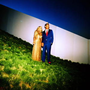 Franca Sozzani, in a gold sequined gown, and Lapo Elkann, in a dark blue suit with a bright red tie, at the Met Gala. Stark white backdrop.