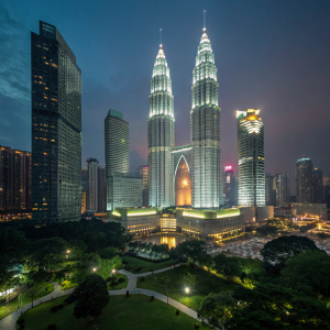 Petronas Towers, lit up at night, from the observation deck of KLCC Park