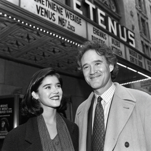 Phoebe Cates and Kevin Kline, both smiling, at the 'Meeting Venus' premiere. Black and white photo with detailed backdrop of Loew's Fine Arts Theater in NYC