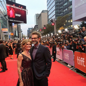Patrick Brammall and Kyra Sedgwick at the premiere of 'Call Your Mother'. Crowded red carpet with flashing cameras.