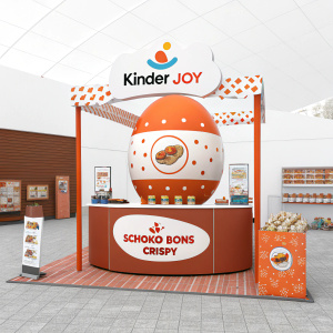 Promotional setup for Kinder Joy Schoko Bons Crispy. Eye-catching and vibrant display featuring a large orange and white round design, detailed info panels, and eye-grabbing banners with the product's name and slogan.