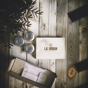 Modern branding design for 'La Urban' pizza place. Features include takeout box, menu card, and containers on a wooden backdrop.