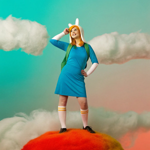Cartoony Fionna posing against a dreamy sky backdrop with fluffy clouds swirling around.