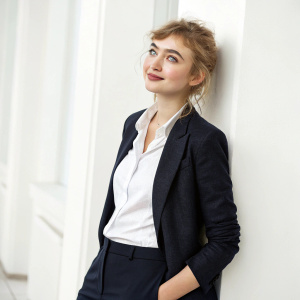 Professional LinkedIn profile photo. Imogen Poots in a business casual outfit, against a clean white background.