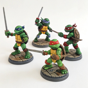 Tiny Teenage Mutant Ninja Turtles figurines in dynamic battle poses, set against a plain white background.