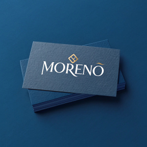 A sleek business card design featuring the brand MORENO. Clean, modern typography against a deep blue background.